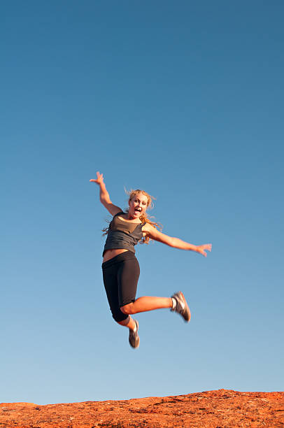 istock Girl jumping high on the red rock ridge 183354453