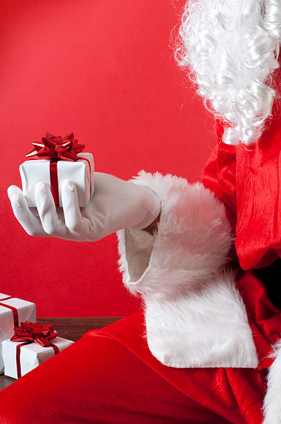 istock Santa Claus holding a Gift 183354498
