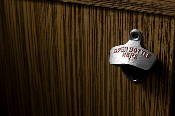 Metal bottle opener attached to a wooden surface
