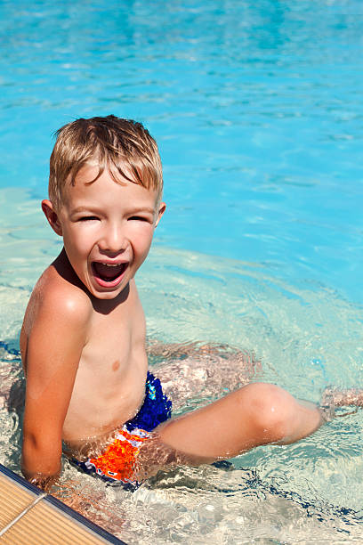 istock Little boy having fun at swimming pool on summer vacations 183356705