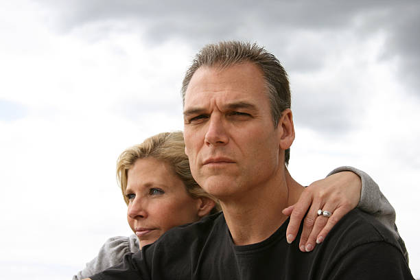 Serious looking older married couple stock photo