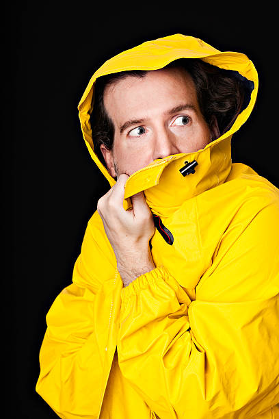 istock Man holding yellow rubber trench coat 183358346