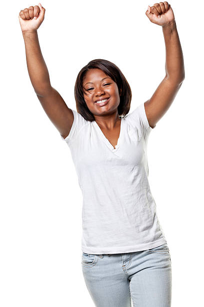 felice giovane donna solleva le braccia - women standing fist success foto e immagini stock