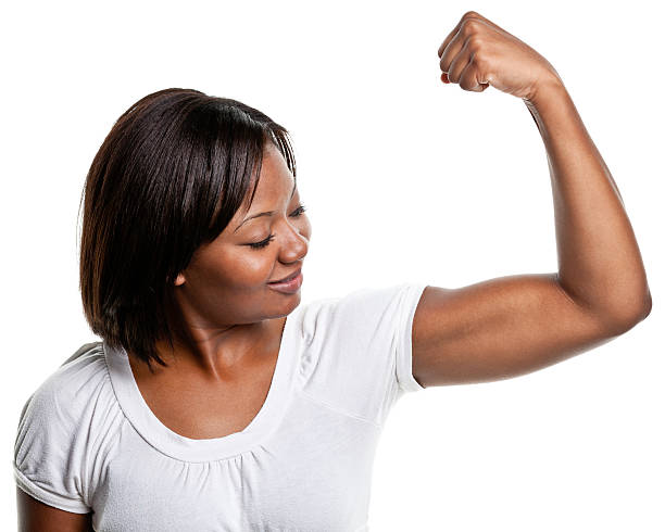 mujer joven flexes bíceps muscular - human muscle women bicep girl power fotografías e imágenes de stock