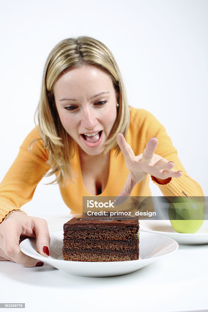 Decision Decision between green apple or sweet chocolate cake. Focus on cake. Shallow DOF. 20-29 Years Stock Photo