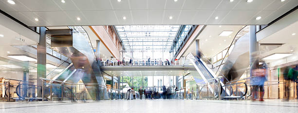 Shopping Mall with Crowd of Shoppers Large modern shopping mall with crowds of people walking.You might also like: shopping mall stock pictures, royalty-free photos & images