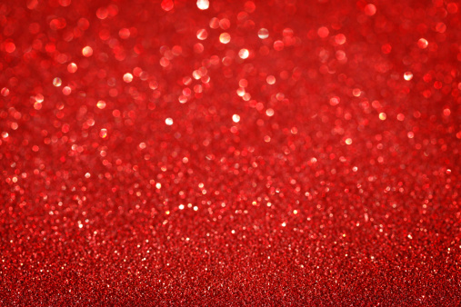 Red glitter Christmas background with some vignetting.