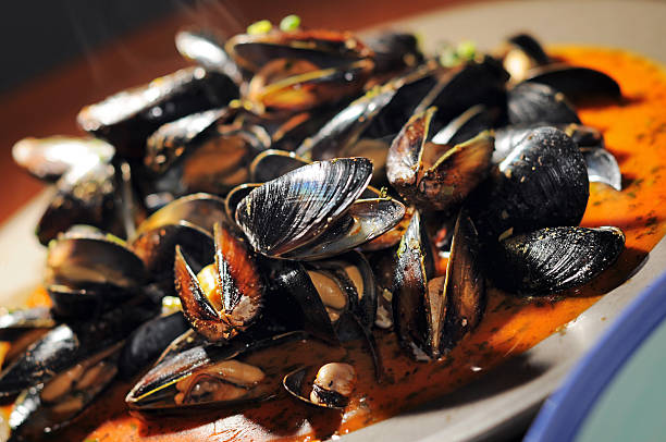 Beautiful cooked mussels in a thai red curry sauce