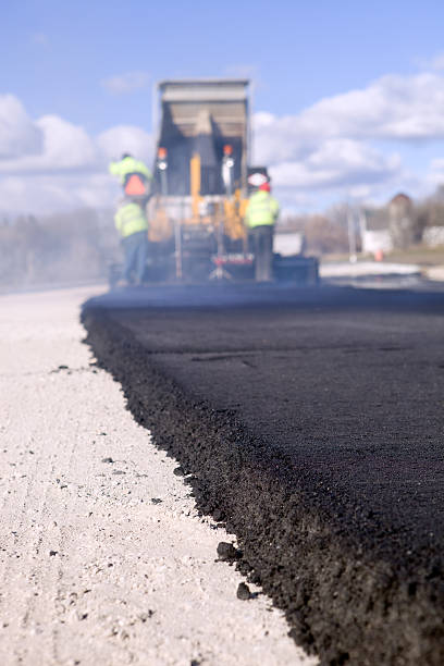istock Blacktop Paving Road with Paver and Dump Truck 183360292