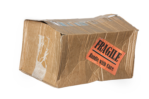 Damaged cardboard parcel with 