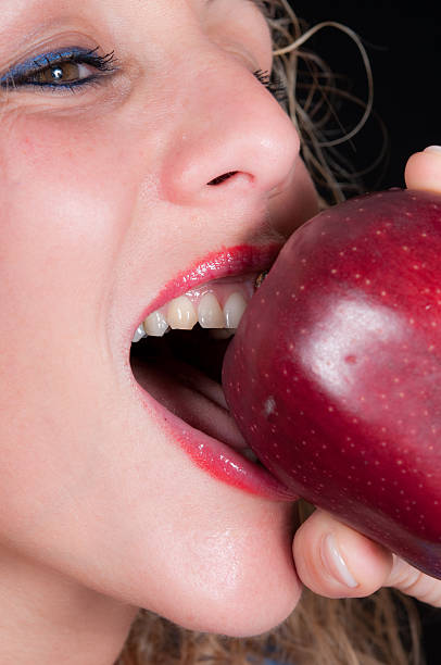 istock Young woman eating an Apple 183360582