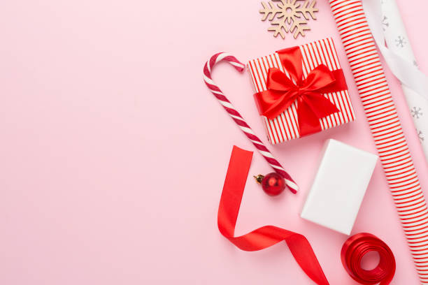 istock Gift boxes with paper's rools and christmas decoration on color background, top view 1833607856