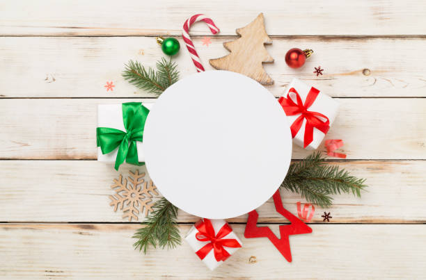 istock Greeting card mockup with christmas decor on wooden background, top view 1833608430