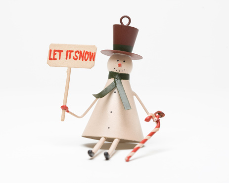 Snowman holding a sign saying LET IT SNOW.