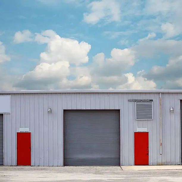 close up shot of industrial building over cloudy sky.