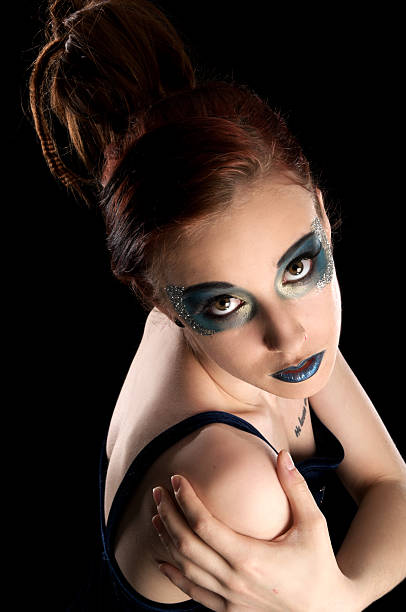 istock Red-head with blue makeup looking up to camera. 183361287