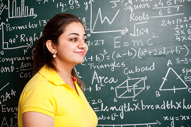 istock Attractive Young Cheerful Indian Mathematics Teacher in Classroom with Greenboard 183361371