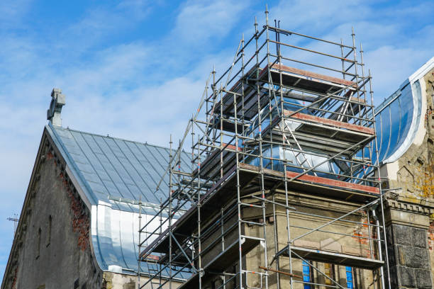 istock Tin roofing replacement of an old Lutheran stone church using complicated scaffolding 1833614551
