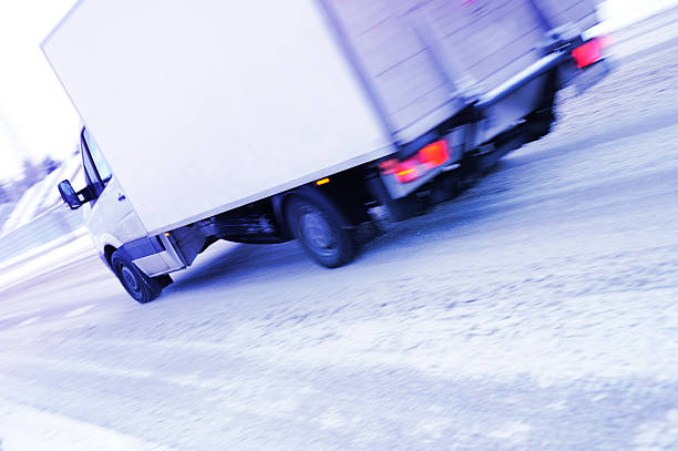 istock Motion blurred truck on snowy winter road 183361488