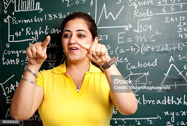 Attractive Young Cheerful Indian Mathematics Girl Teacher Classroom With Greenboard Stock Photo - Download Image Now