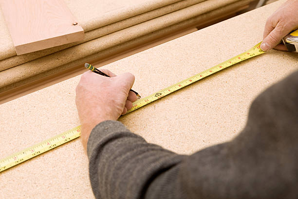 istock Carpenter Measuring and Marking Stair Tread for a Cut 183361827