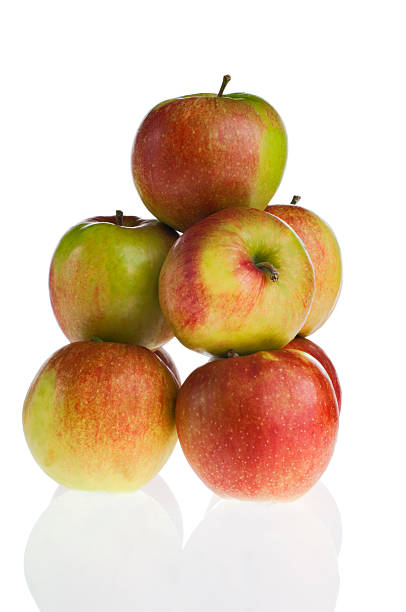 pila di mele fresche isolato su bianco - jona gold foto e immagini stock