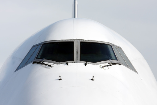 Aircraft cockpit close-up with airbridge connected to the aircraft