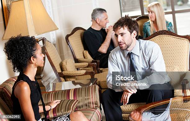 Friends In Hotel Lobby Stock Photo - Download Image Now - Group Of People, Hotel Reception, Luxury Hotel