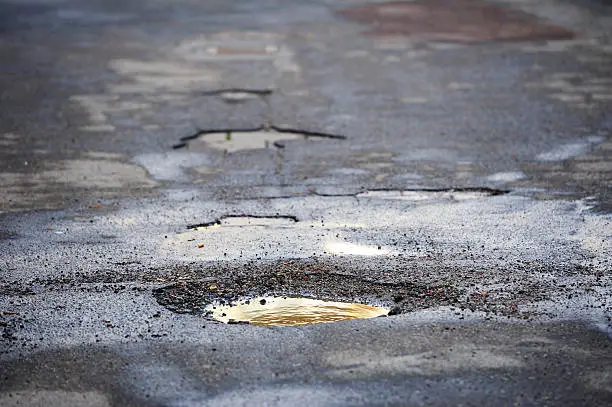 Photo of Pot hole on asphalt road