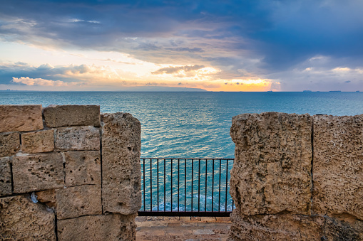 Seawall at the waterfront in the Old City of Acre, Israel at sunset.