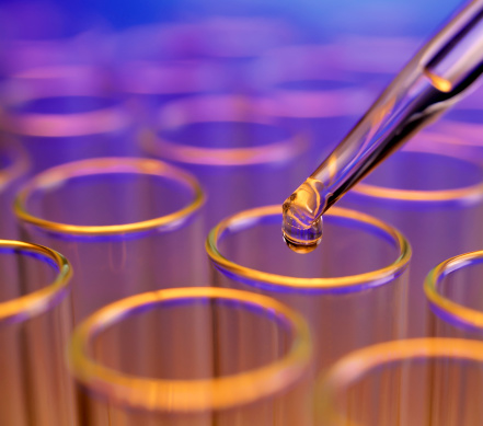 Liquid drop falling into test tubes.See More in this Lightbox: