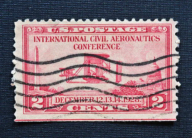 "The 25th anniversary of the Wright brothers' historic first powered flight was celebrated with stamps issued on December 12, 1928. The issue corresponded with the International Civil Aeronautics Conference held in the District of Columbia. The   stamp, a 2-cent red  , depicts the Wright Flyer as well as theThe Washington Monument and the U.S. Capitol ."