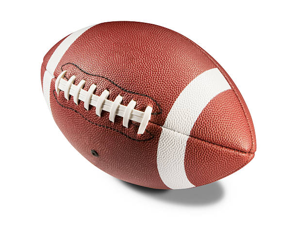 Brown and white American football on white background A brown and white american football isolated on a white background with a clipping path. The ball casts a shadow on the white background underneath it. The leather is textured and has white lines painted around either end of it with white laces stitched down the middle. american football ball stock pictures, royalty-free photos & images