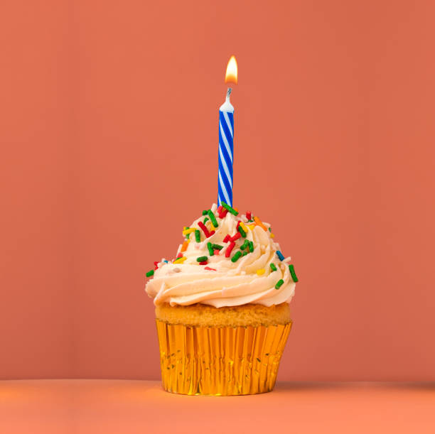 istock Birthday card with cupcake and lit candle 1833645783