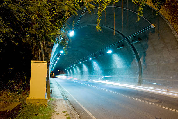 istock illuminated highway tunnel with vehicle light streaks 183364588