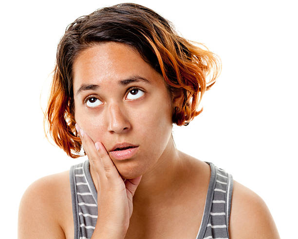 Young Woman Portrait Portrait of a young woman on a white background.http://s3.amazonaws.com/drbimages/m/aprsie.jpg rolling eyes irritation displeased facial expression stock pictures, royalty-free photos & images