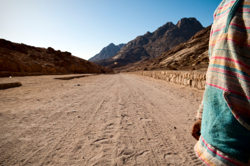 A Bedouin boy in Egypt stands on a dirt road leading to St. Catherine's Monastery.
