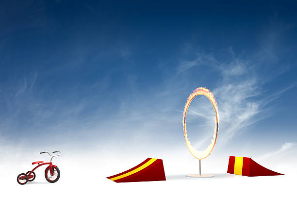 Ring of fire stunt "Dangerous stunt with tricycle, jump and flaming ring of fire. Could be useful in a composition about risk.This is a detailed 3d rendering." Ring Of Fire stock pictures, royalty-free photos & images