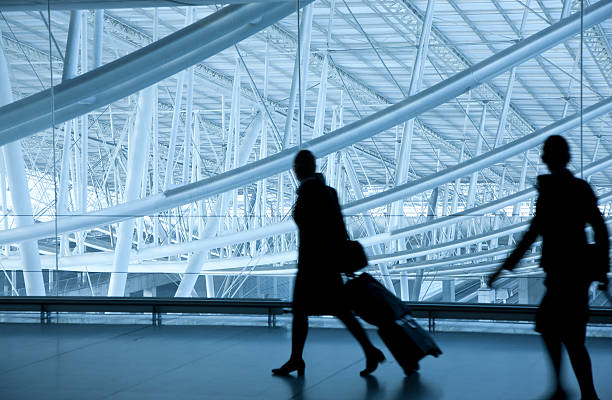 istock Two Stewardesses Walking at Airport, Pulling Luggage 183365468
