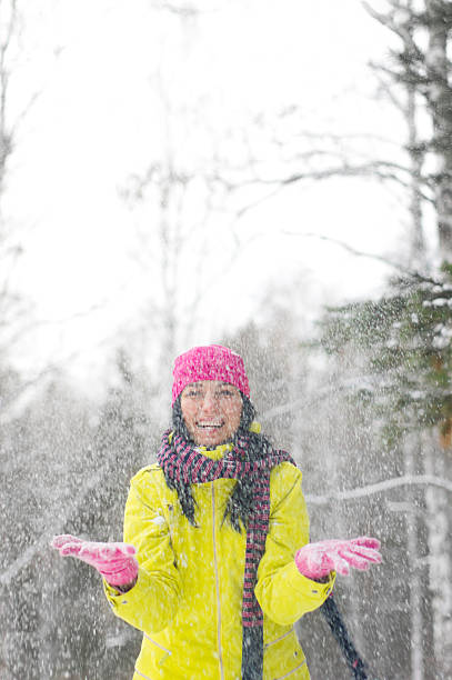istock Happy woman catching snowflakes 183365570