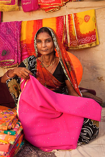 istock Woman selling colorful fabrics 183366357