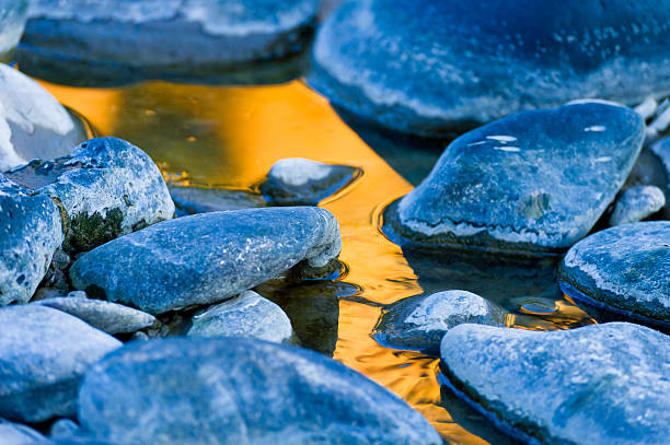 istock Cool Rocks and Warm Reflection in Water by the River 183366720