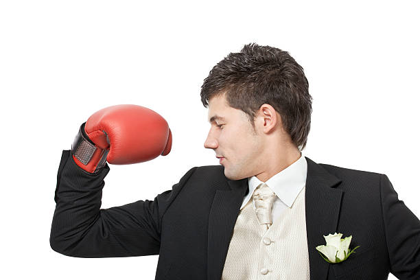 istock young man wearing boxing gloves 183366804