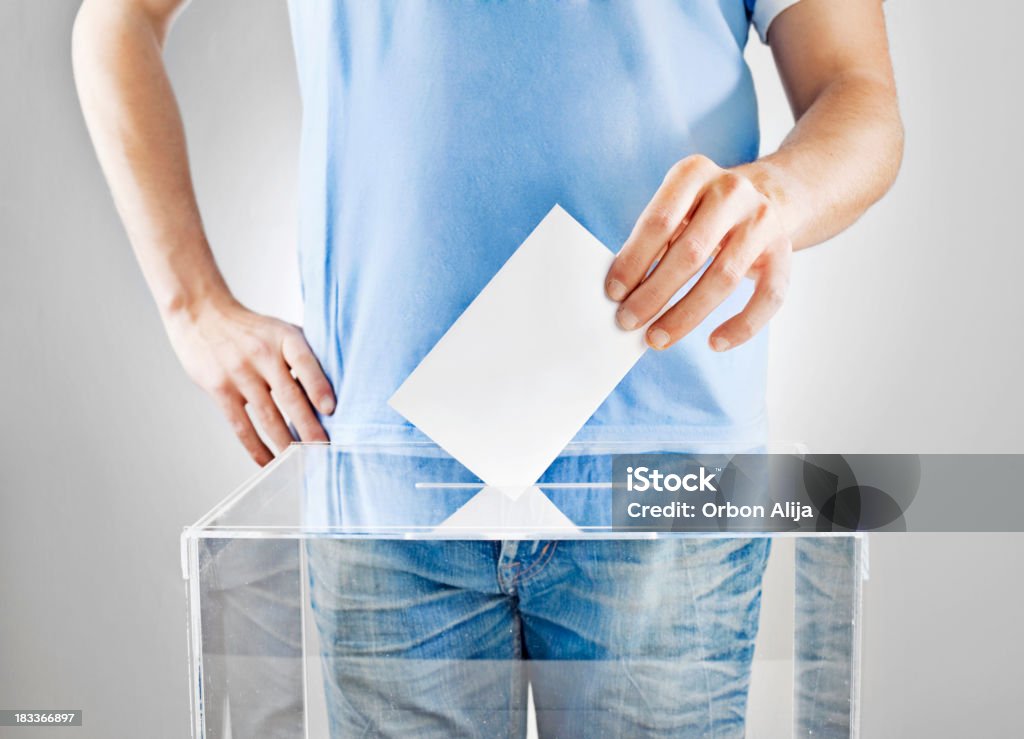 Vote! A young man voting Voting Stock Photo