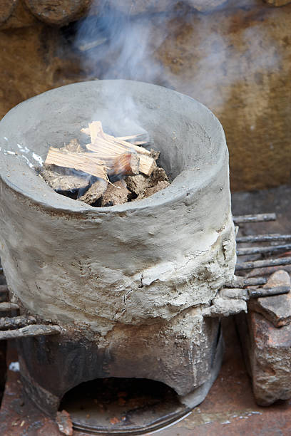 istock Clay oven with wood and smoke in it 183367211