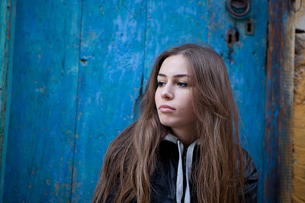 istock young woman by the door 183367397