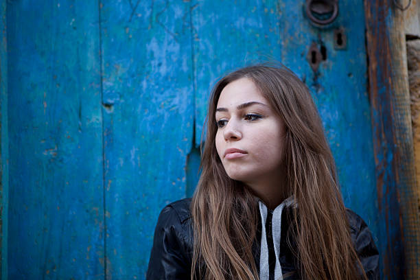 istock young woman by the door 183367448