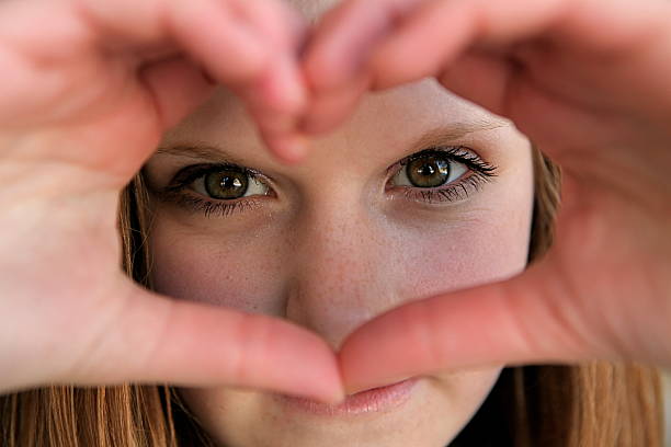 istock Girl Peeking Through Heart Shape 183367581