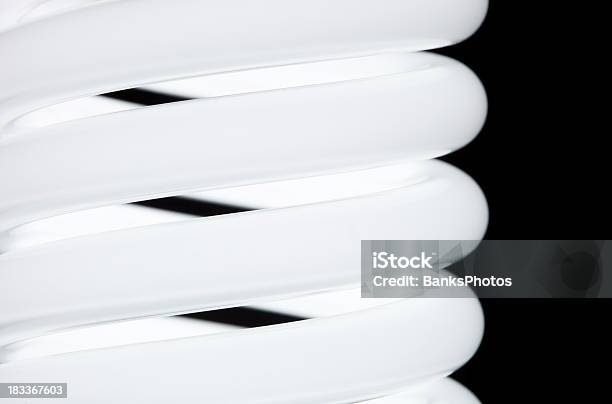 Compact Fluorescent Lightbulb Coils Isolated On Black Stock Photo - Download Image Now