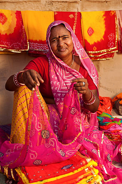 istock Woman selling colorful fabrics 183367819